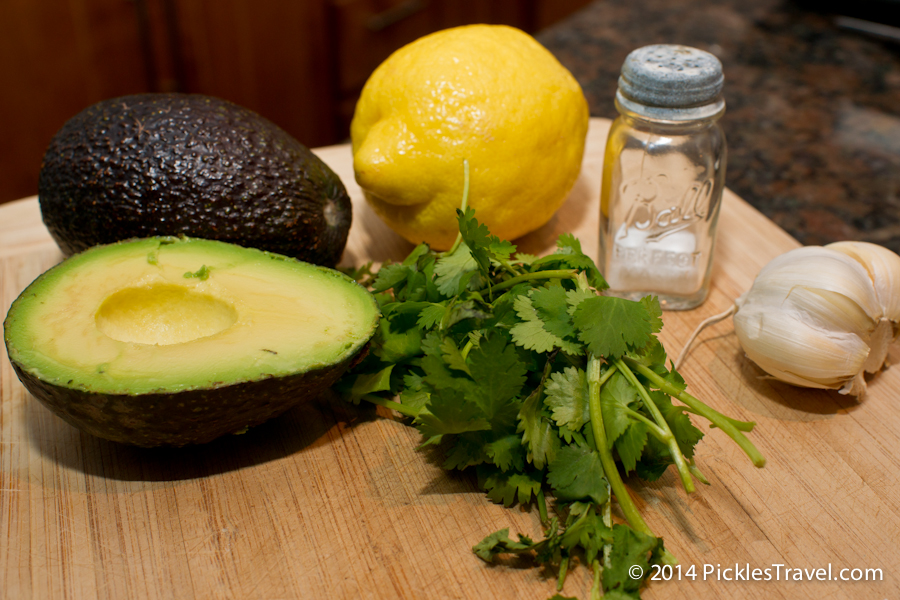 guacamole recipe ingredients: lemon, avocado, garlic, salt and cilantro