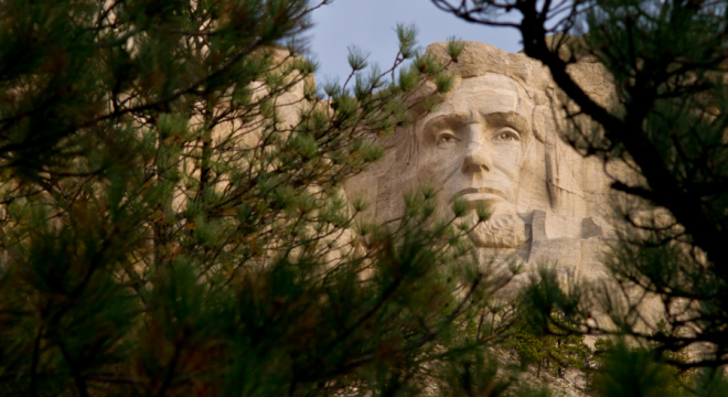 Abe Lincoln peeks out from the trees at Mount Rushmore